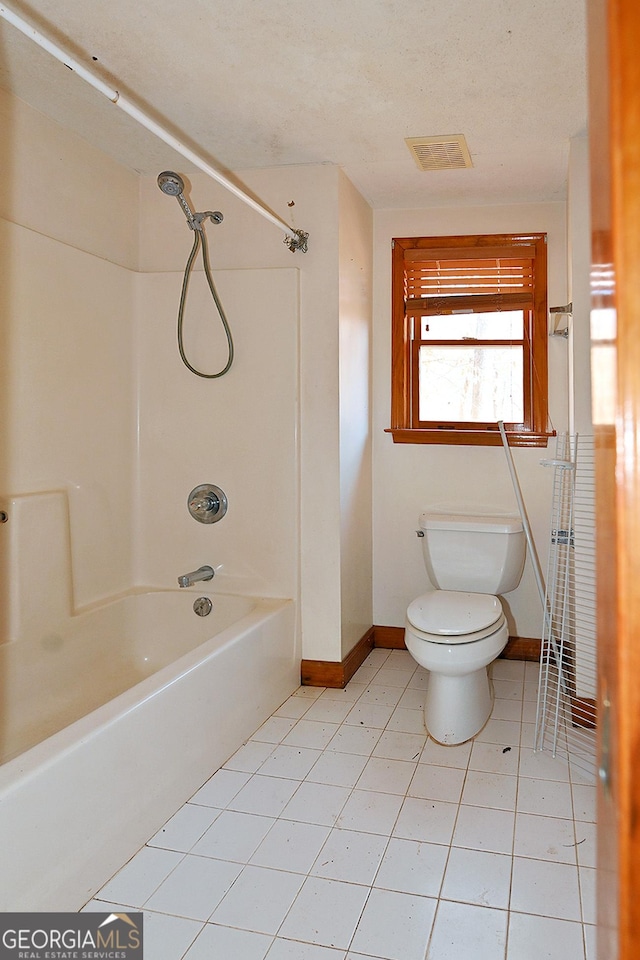 full bathroom featuring shower / bathtub combination, visible vents, toilet, tile patterned flooring, and baseboards