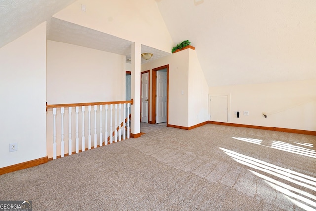 additional living space with lofted ceiling, carpet floors, and baseboards