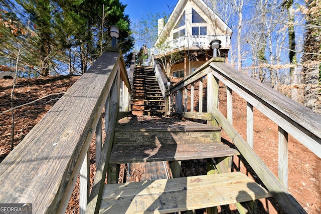 rear view of property featuring stairs