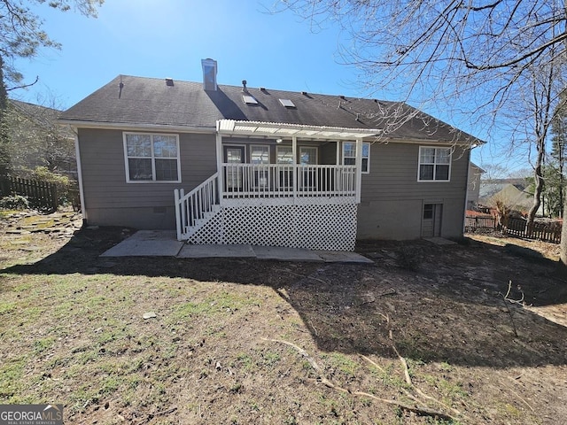 back of property with crawl space, a shingled roof, fence, and a pergola