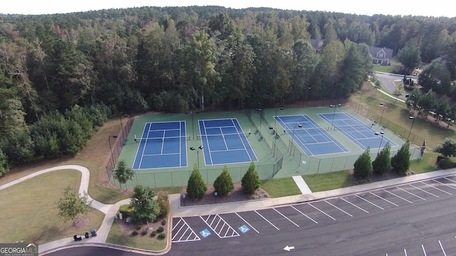 birds eye view of property with a wooded view