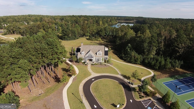 drone / aerial view featuring a water view and a forest view