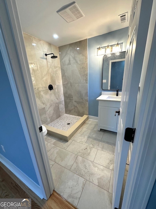 full bathroom featuring visible vents, toilet, a shower stall, and vanity