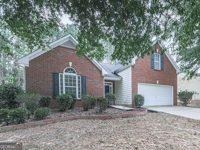 traditional-style home with concrete driveway, brick siding, and an attached garage