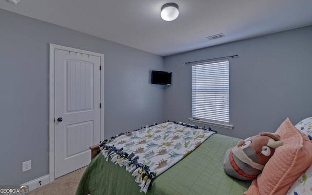 bedroom with carpet floors, visible vents, and baseboards