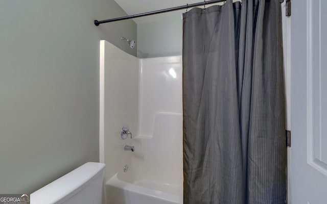 bathroom featuring toilet and shower / bath combo with shower curtain