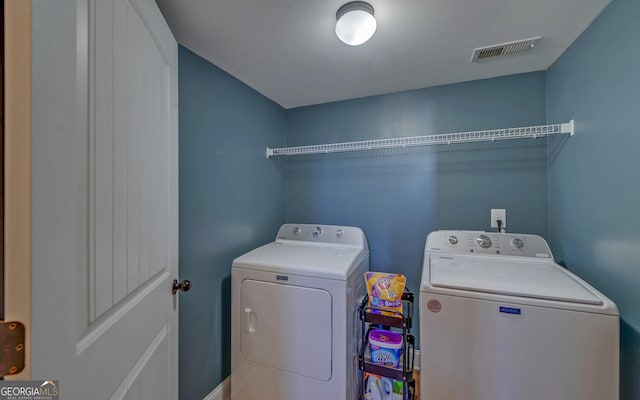 laundry area featuring laundry area, visible vents, and separate washer and dryer