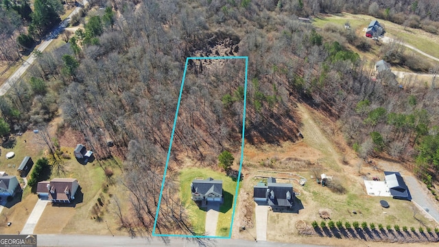 birds eye view of property with a rural view