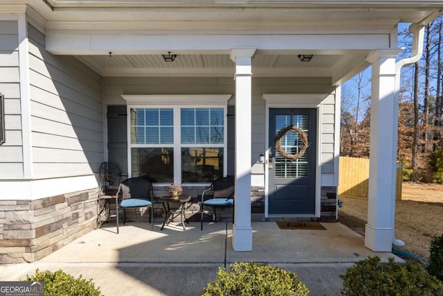 view of exterior entry with covered porch