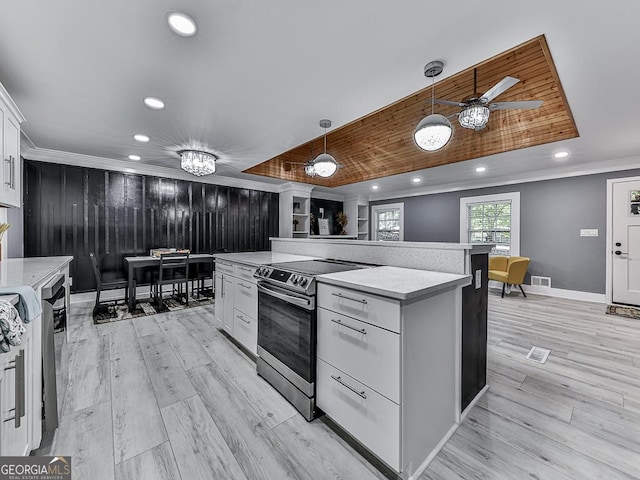 kitchen with white cabinets, electric stove, ornamental molding, light countertops, and pendant lighting