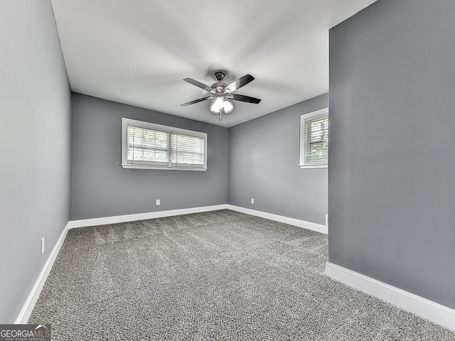 unfurnished room featuring carpet, a ceiling fan, and baseboards