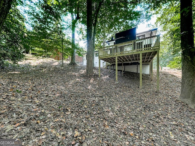 view of yard featuring a wooden deck