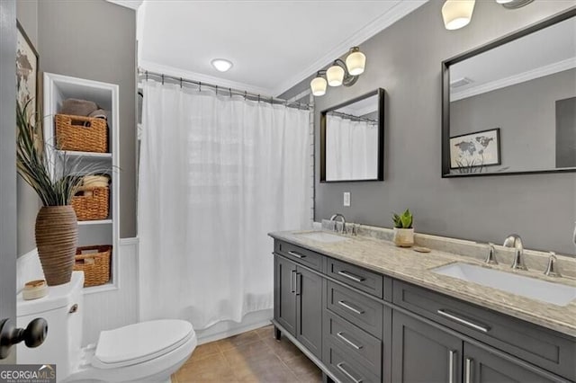 bathroom with tile patterned flooring, ornamental molding, and a sink