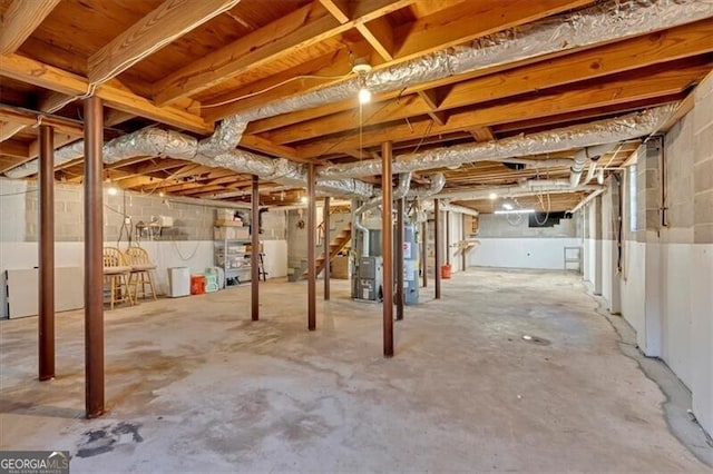 unfinished basement featuring heating unit