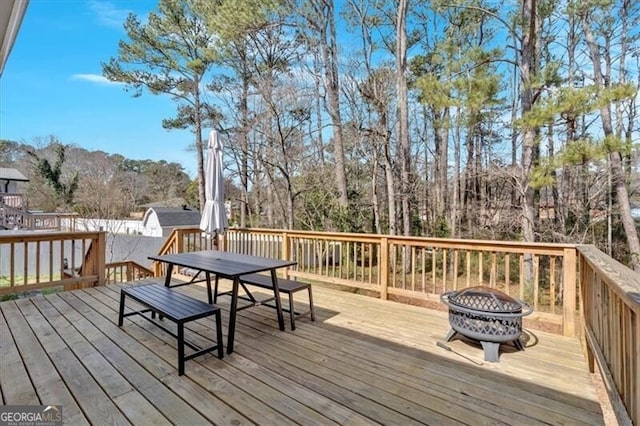 deck featuring a fire pit and outdoor dining space