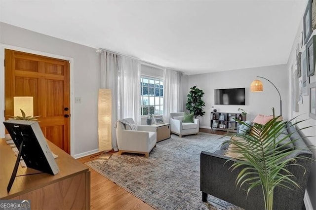 living room with wood finished floors and baseboards