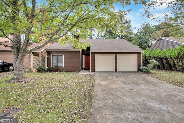 ranch-style home featuring a garage, concrete driveway, and roof with shingles