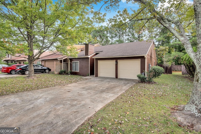 view of front of home featuring a garage, fence, concrete driveway, a front lawn, and a chimney