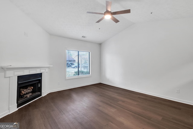 unfurnished living room with visible vents, lofted ceiling, dark wood-style flooring, a textured ceiling, and a fireplace