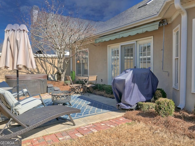 view of patio / terrace featuring a hot tub and area for grilling