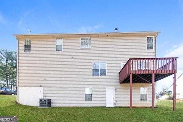 rear view of house with a lawn, a wooden deck, and central air condition unit