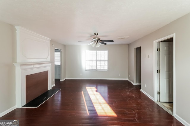 unfurnished living room featuring a fireplace, dark wood finished floors, a ceiling fan, and baseboards