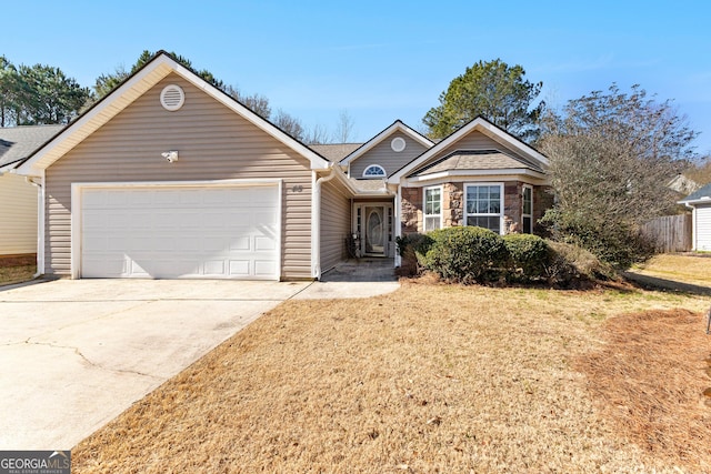 single story home with a garage, driveway, a front lawn, and stone siding