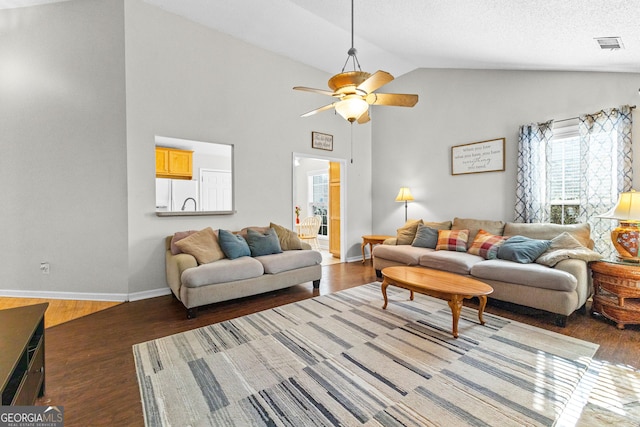 living area featuring dark wood-style floors, baseboards, visible vents, and a ceiling fan