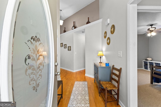 hall featuring light wood-style floors and baseboards