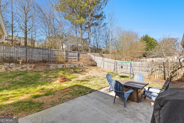 view of yard with outdoor dining space, an outdoor fire pit, a fenced backyard, and a patio