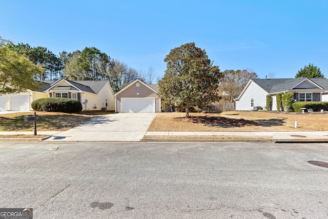 single story home with a garage and fence