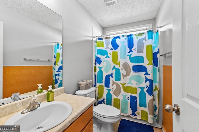 bathroom with a textured ceiling, toilet, a shower with shower curtain, visible vents, and vanity