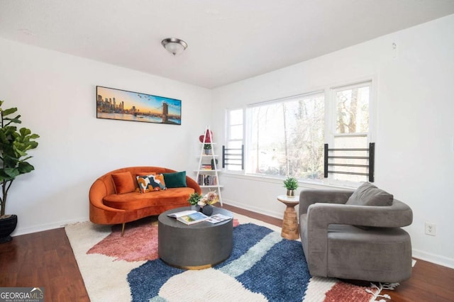 living room with baseboards and dark wood-style flooring