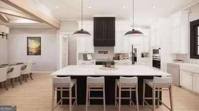 kitchen with a kitchen bar, light countertops, and a center island