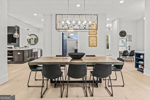 dining room with light wood-type flooring and recessed lighting