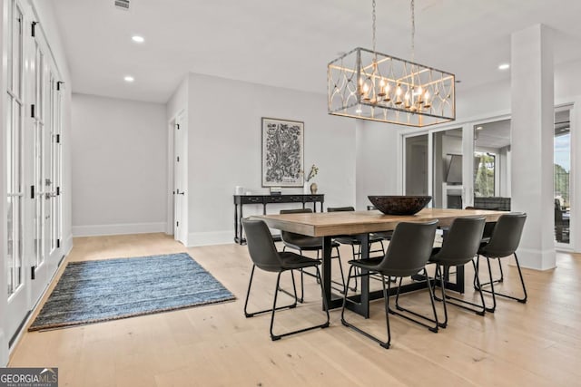 dining room featuring baseboards, light wood finished floors, and recessed lighting