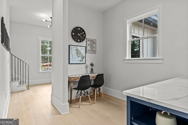 office area with baseboards and light wood-style floors