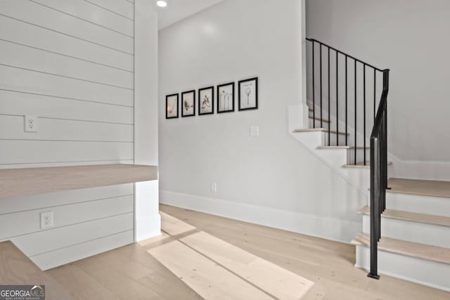 interior space featuring baseboards, wood finished floors, and recessed lighting