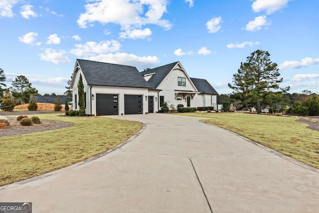 modern farmhouse style home featuring a garage, driveway, roof with shingles, board and batten siding, and a front yard