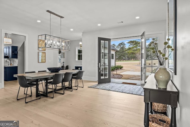 dining room featuring recessed lighting, light wood-style flooring, and baseboards