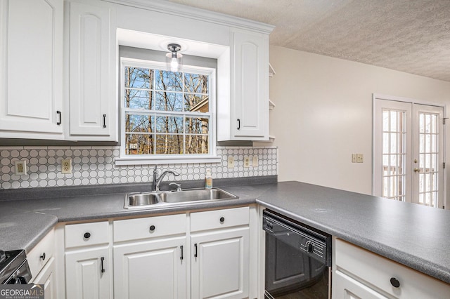 kitchen with dark countertops, black dishwasher, white cabinetry, and a sink