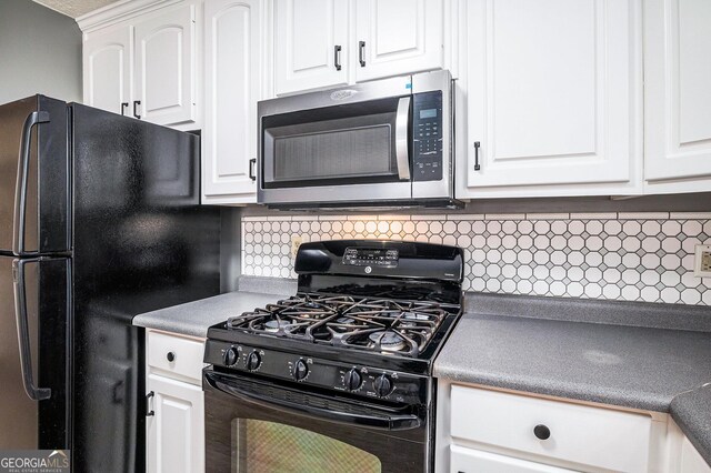 kitchen with light countertops, white cabinetry, backsplash, and black appliances