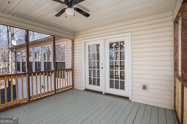 unfurnished sunroom with ceiling fan