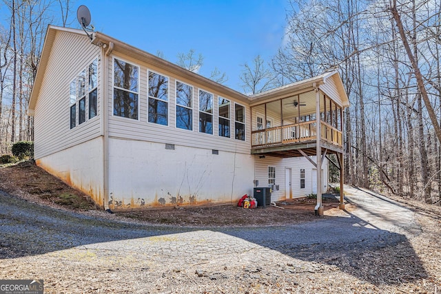 back of house featuring ceiling fan, a balcony, and central AC unit