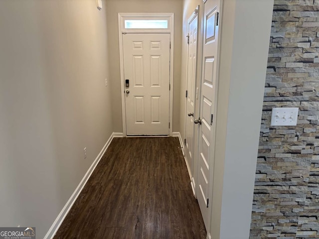 doorway to outside with dark wood-style floors and baseboards