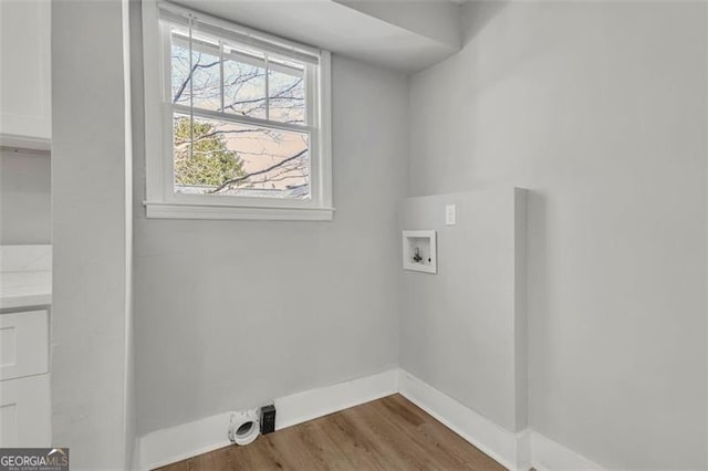 clothes washing area with laundry area, hookup for a washing machine, baseboards, and dark wood-type flooring