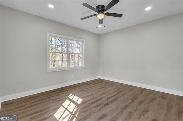 empty room with a ceiling fan, baseboards, dark wood-style flooring, and recessed lighting