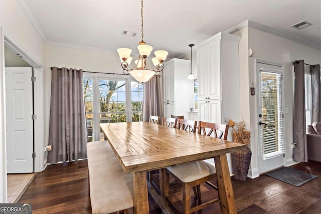 dining area with visible vents, dark wood finished floors, and ornamental molding