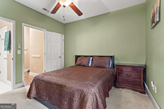 bedroom featuring light carpet, a ceiling fan, visible vents, and baseboards