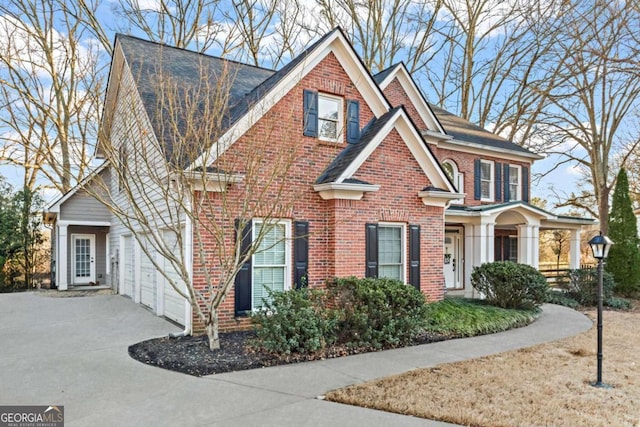 view of front facade with concrete driveway, brick siding, and an attached garage